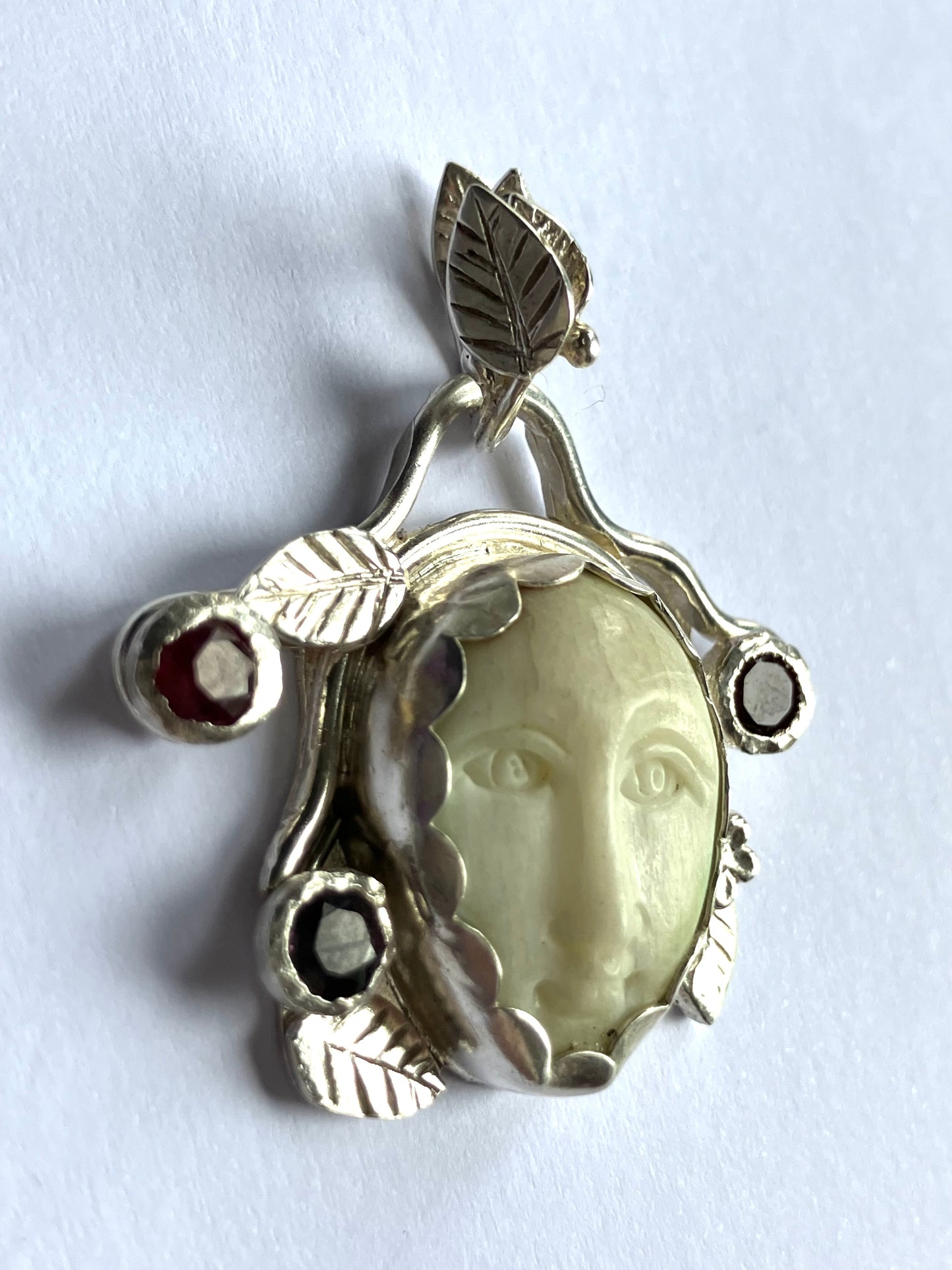 Face Pendant in Carved Bone With Silver & Red Garnet