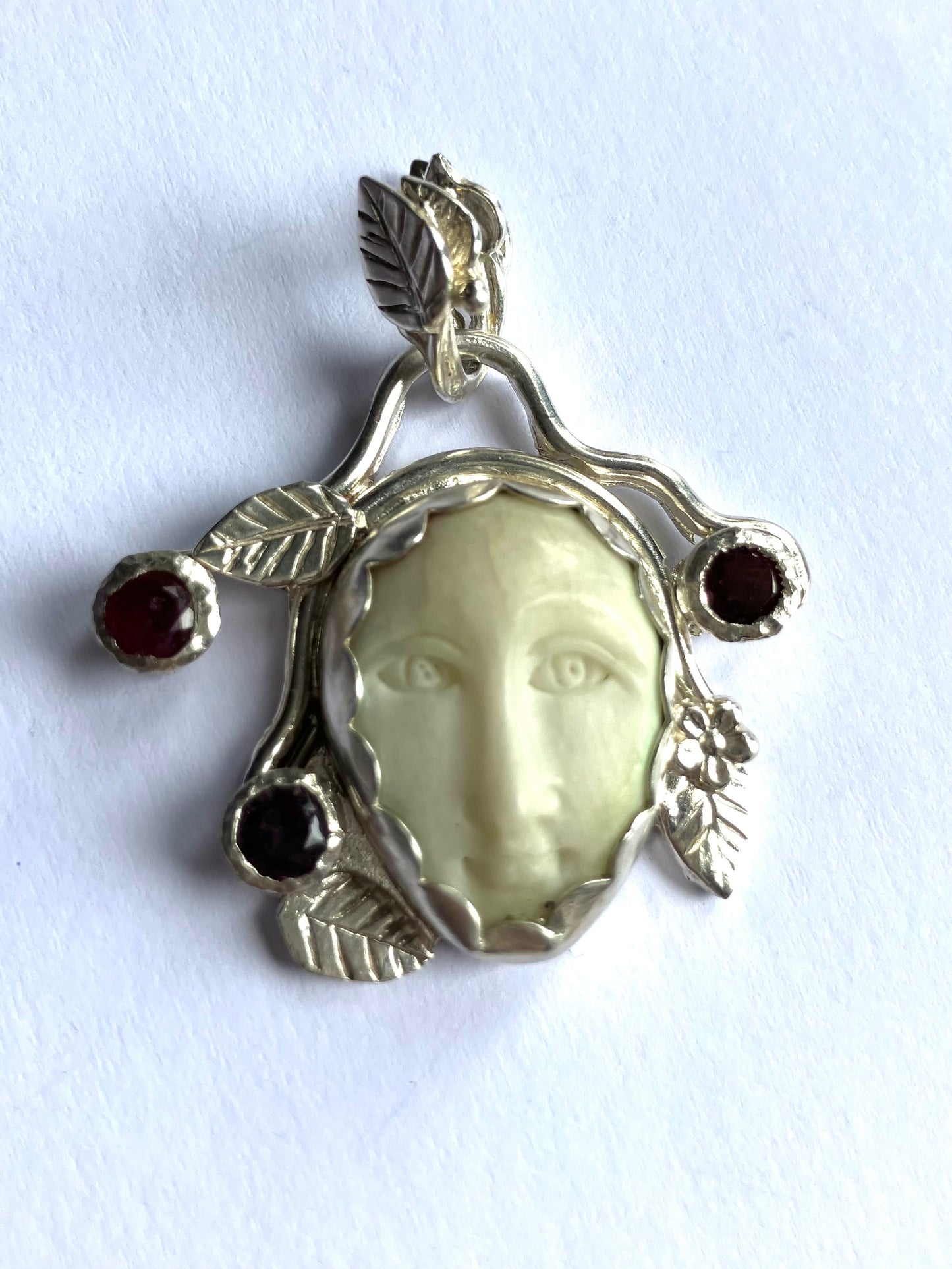 Face Pendant in Carved Bone With Silver & Red Garnet