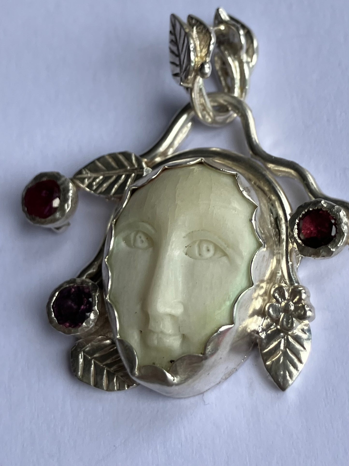 Face Pendant in Carved Bone With Silver & Red Garnet