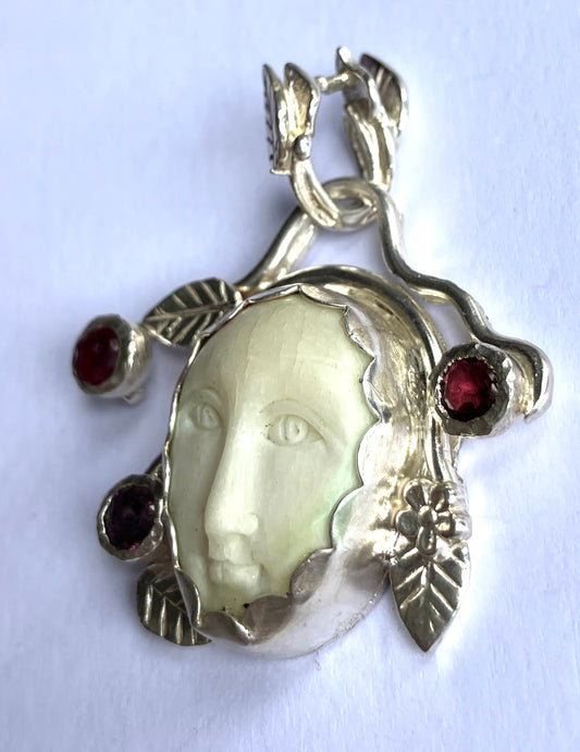 Face Pendant in Carved Bone With Silver & Red Garnet