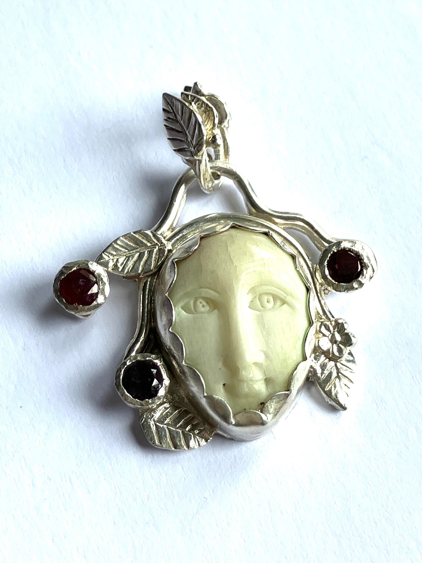 Face Pendant in Carved Bone With Silver & Red Garnet