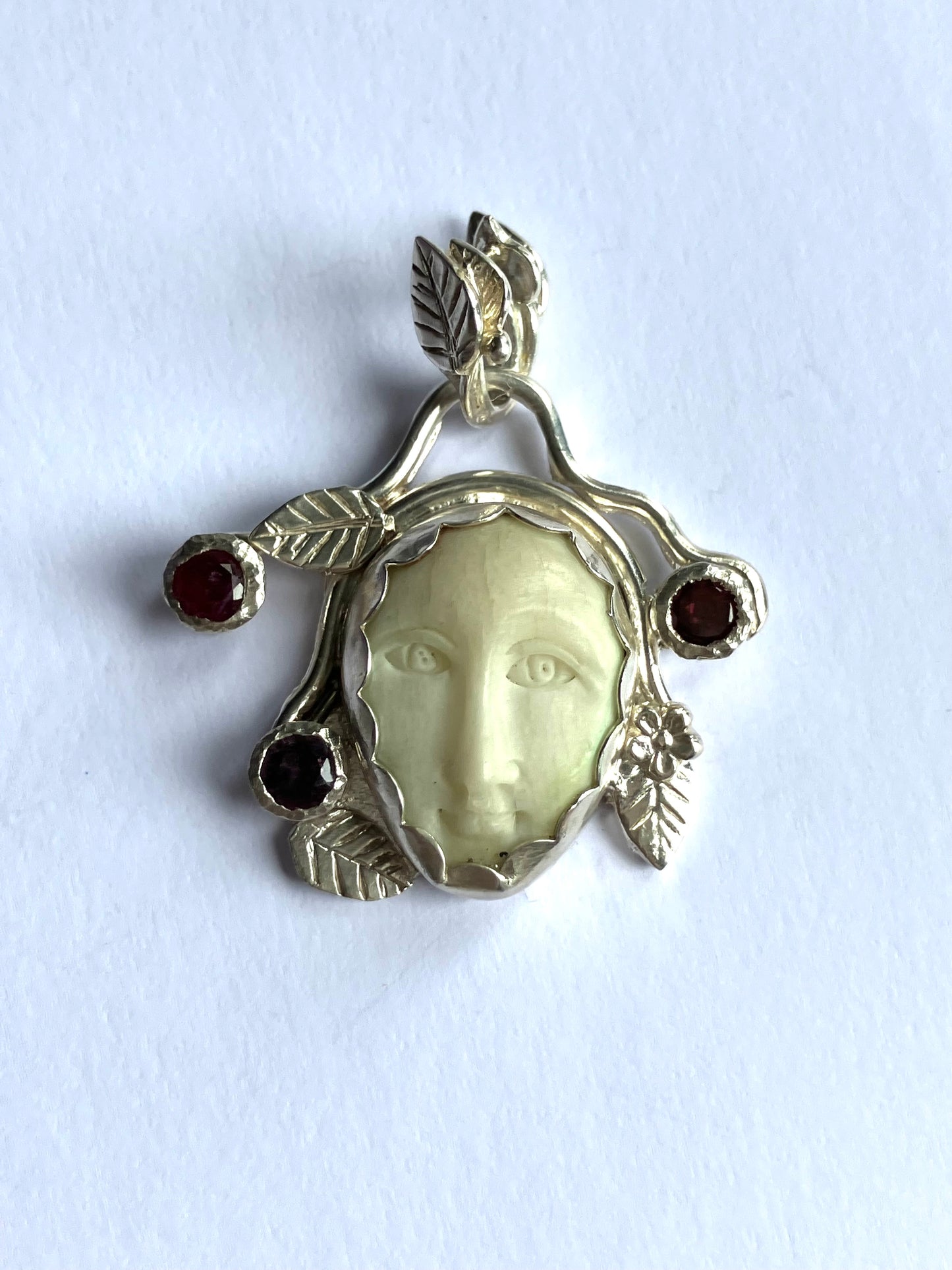 Face Pendant in Carved Bone With Silver & Red Garnet