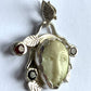 Face Pendant in Carved Bone With Silver & Red Garnet