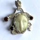 Face Pendant in Carved Bone With Silver & Red Garnet