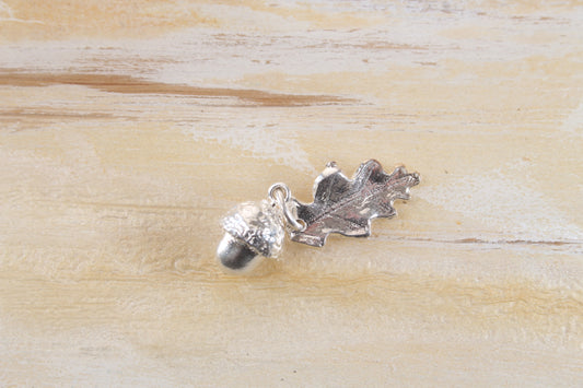 Small solid silver acorn pendant with leaf